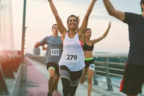 woman running happy arms up with no concern of stress incontinence Gloucester
