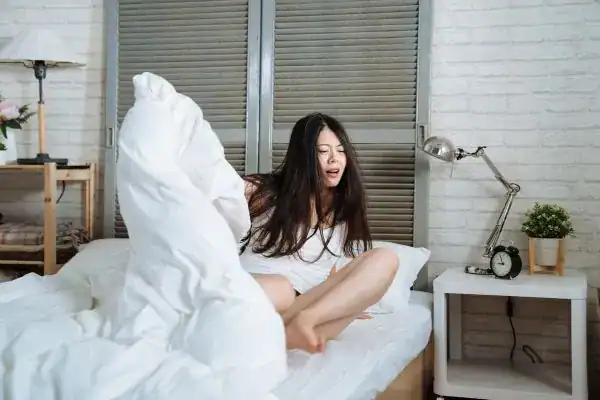 Image of woman getting up because of nighttime leaks Gloucester